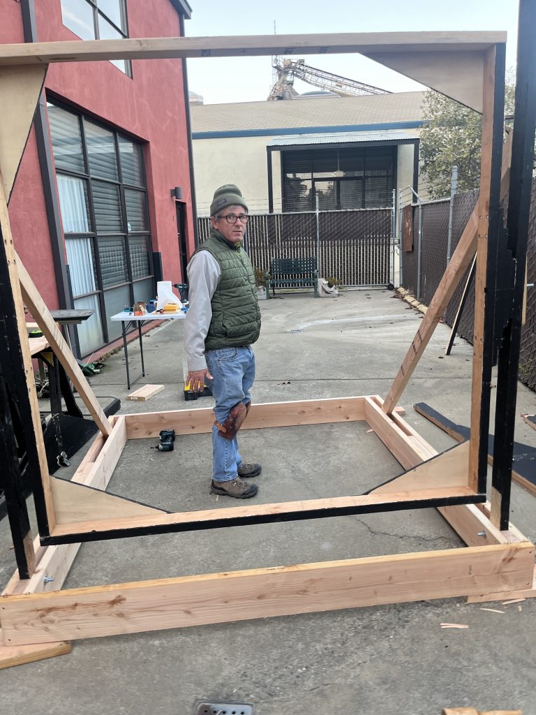 Artist "Bill" standing in the in progress PF3000 v2 frame